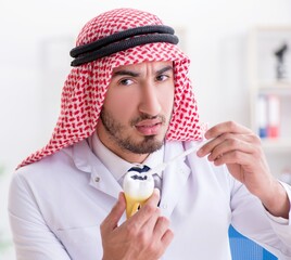 Arab dentist working on new teeth implant