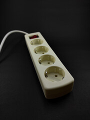 Photo of a white electrical terminal extension isolated on a black background, Not Focus