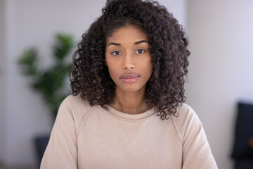 Young black woman at home serious face portrait