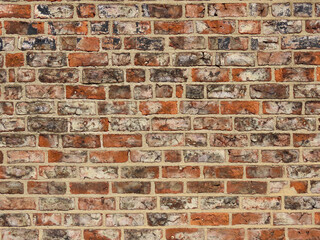 Very old red brick wall with black soot marks from fire in York, England, traditional pattern,...