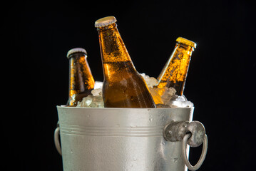 beer bottle chilled in ice in wine cooler tank