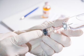 doctor hands hold syringe and drug bottle