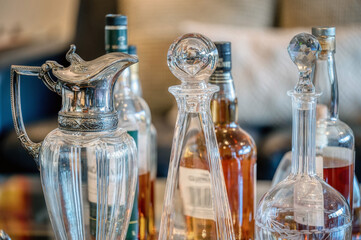 Whiskey, brandy and vintage decanters on a silver tray 
