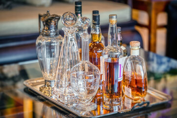 Whiskey, brandy and vintage decanters on a silver tray 