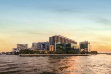 Public hospital, Faculty of Medicine Siriraj Hospital at twilight time in the Chao Phraya River, Bangkok, Thailand