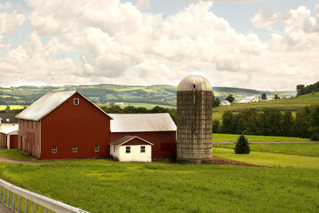 American Farm, bright red barn on green field 