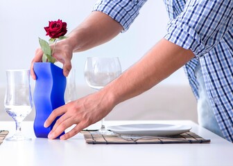 The man alone preparing for romantic date with his sweetheart