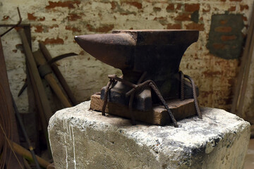 Old black anvil for forging metal in a smithy or forge