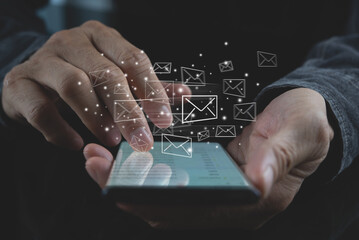 Close up of business man using mobile smart phone with e-mail icons on virtual screen, sending email concept