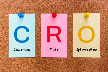 Conceptual 3 letters keyword CRO (Conversion Rate Optimization) on multicolored stickers attached...
