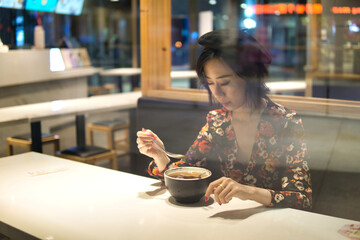 Asian women eating dessert in restaurant.