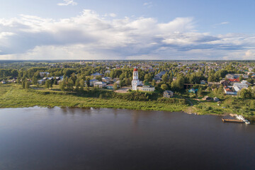 Fototapeta na wymiar Ancient Assumption Church with a bell tower in the cityscape on August day (aerial view). Totma, Vologda region. Russia