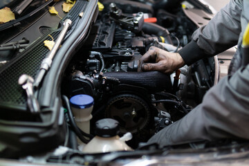 Close up hands of auto mechanic doing car service and maintenance. Services car engine machine.