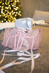 pink corsage on the bed against the background of gifts