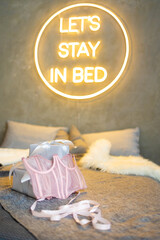 pink corsage on the bed against the background of gifts