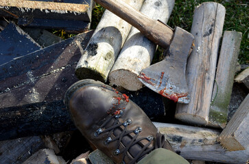 camping skills father with son. chopping wood logs from willow in autumn. the father shows with ax what can happen like cutting off an arm, fingers, foot. in the background wooden beehives beekeeper