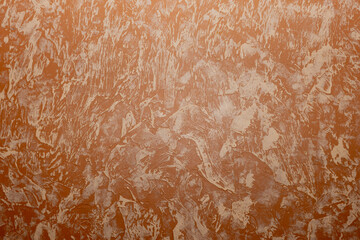 Abstract drawing with white strokes on a brown wall.