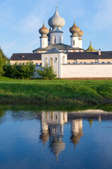 Near the walls of the ancient Tikhvin Assumption Monastery on a sunny August evening. Leningrad region, Russia