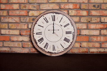 Vintage clock near a brick wall