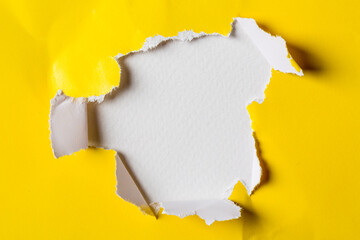 Close up torn yellow paper hole background