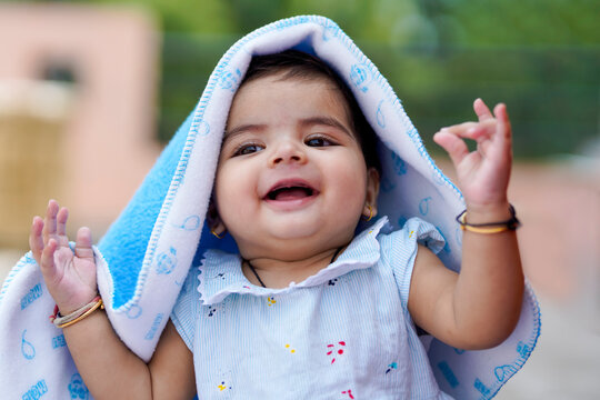 Indian baby girl child playing and giving smile