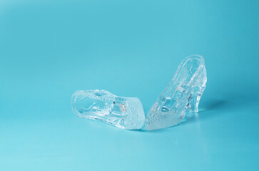 A pair of souvenir crystal shoes on a blue background