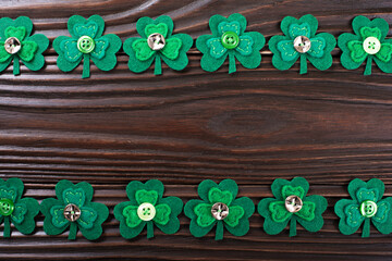 Shamrock leaves on dark wooden background with copy-space flat lay view