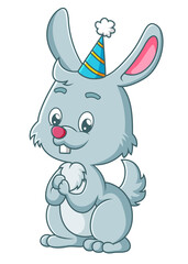 The happy rabbit is wearing the birthday hat