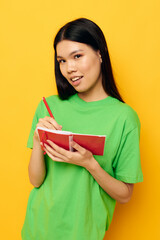 woman with Asian appearance notebook and pen learning education isolated background unaltered