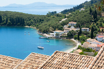 Fototapeta na wymiar Beautiful bay with beach in Kalami village, Corfu island, Greece. Panoramic top view of beautiful mediterranean landscape