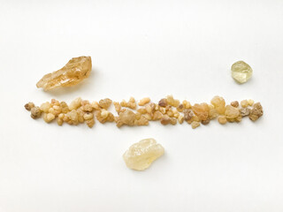 Natural incense, frankincense resin and dammar close-up on a white background, place for text.