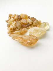 Natural incense, frankincense resin and dammar close-up on a white background, place for text.