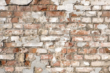 Old brick wall with peeling plaster, grunge background. Old concrete stucco brick wall texture urban background. Brickwall background. Structure with broken plaster and stucco.