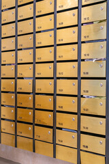Metallic letter mailbox array at condominium entrance hall