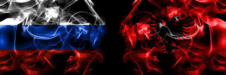 Russia, Russian vs Albania, Albanian flags. Smoke flag placed side by side isolated on black background