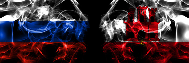Russia, Russian vs British, Britain, Gibraltar flags. Smoke flag placed side by side isolated on black background