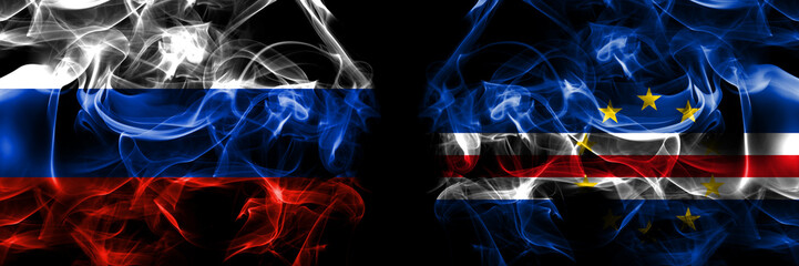 Obraz premium Russia, Russian vs Cape Verde, Cabo Verde flags. Smoke flag placed side by side isolated on black background