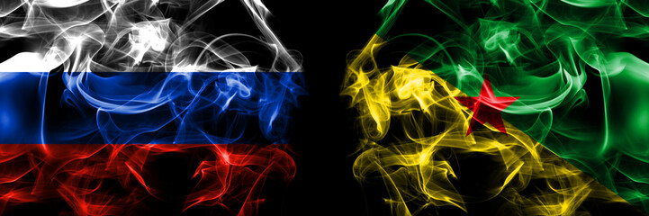Russia, Russian vs France, French Guiana flags. Smoke flag placed side by side isolated on black background
