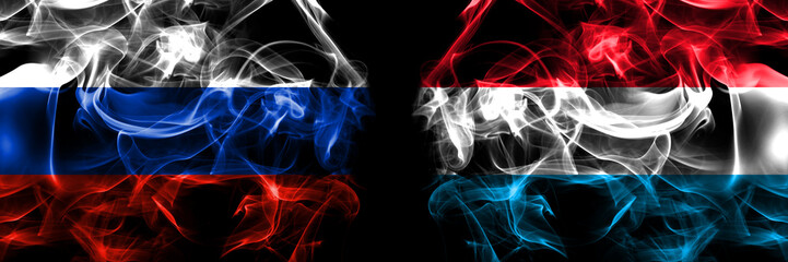 Russia, Russian vs Luxembourg flags. Smoke flag placed side by side isolated on black background