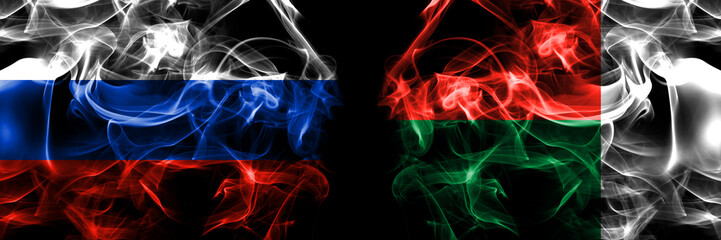 Russia, Russian vs Madagascar flags. Smoke flag placed side by side isolated on black background