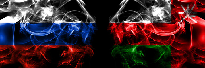 Russia, Russian vs Oman flags. Smoke flag placed side by side isolated on black background
