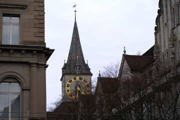 Famous Bahnhofstrasse with church tower of protestant church St. Peter in the background on a...