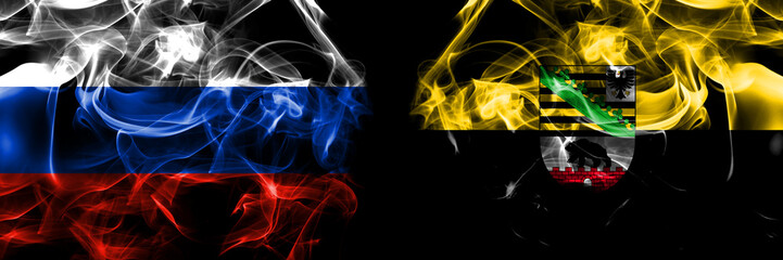 Russia, Russian vs Saxony Anhalt, state flags. Smoke flag placed side by side isolated on black background