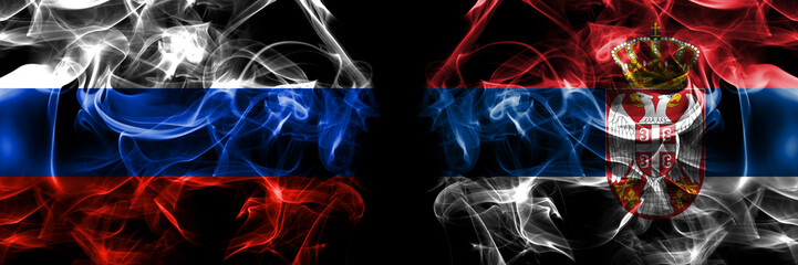 Russia, Russian vs Serbia, Serbian flags. Smoke flag placed side by side isolated on black background