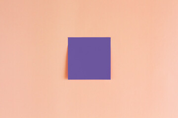 Square sticky note sheet on coral background. Color of the year 2022 from pantone. Very peri.