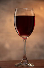 glass of red wine on wood table