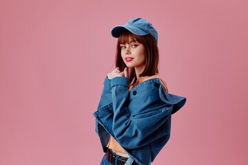 Portrait of a charming lady in a cap and denim jacket posing color background unaltered