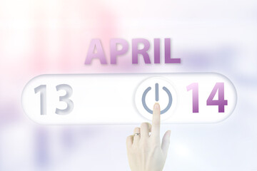 April 14th. Day 14 of month, Calendar date.Hand finger switches pointing calendar date on sunlight office background. Spring month, day of the year concept.