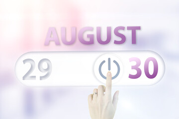 August 30th. Day 30 of month, Calendar date.Hand finger switches pointing calendar date on sunlight office background. Summer month, day of the year concept.