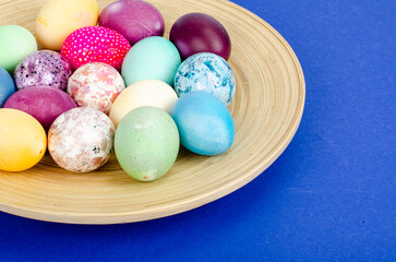 Decorated handmade Easter eggs for the holiday season on blue background. Creative minimal abstract concept. Studio Photo